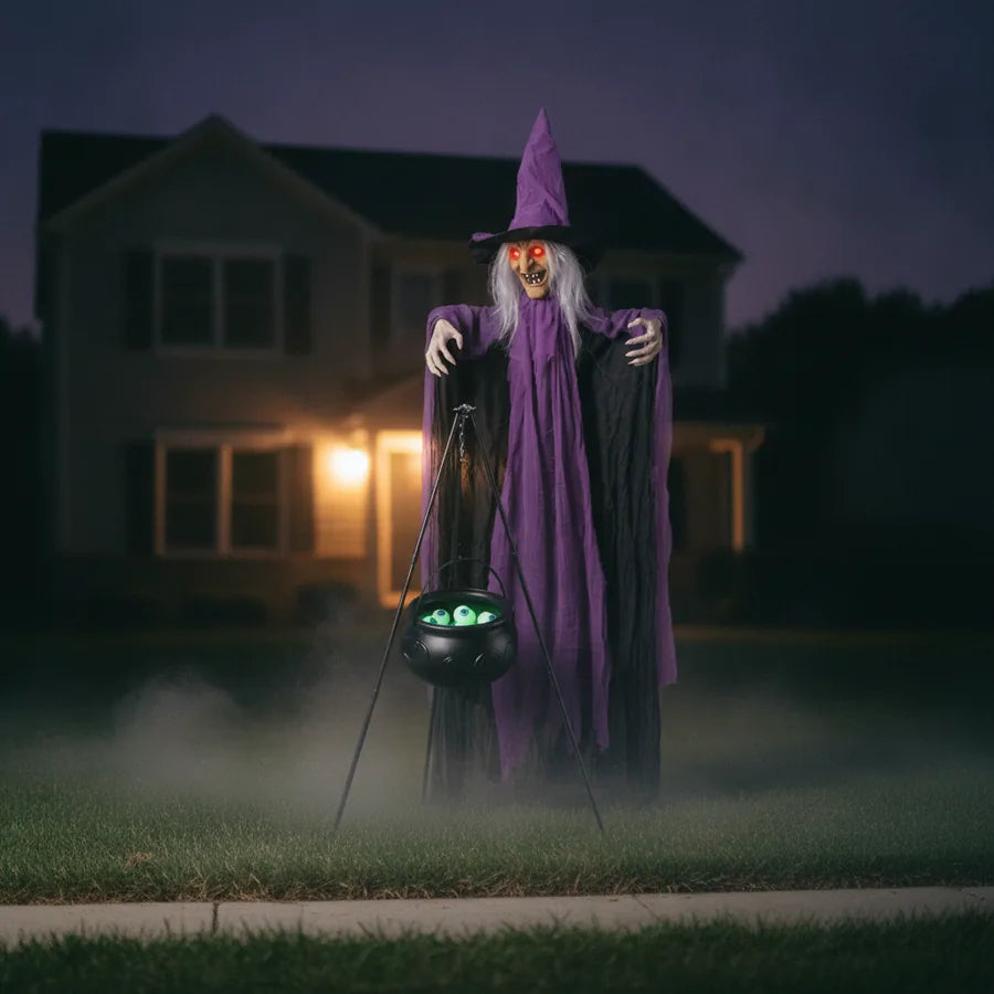 Blackmoor Witch Animatronic set up on a suburban front lawn at night, lit against the house