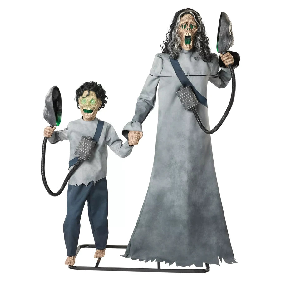 The pair hand in hand on one metal frame, masks lowered and both faces lit green