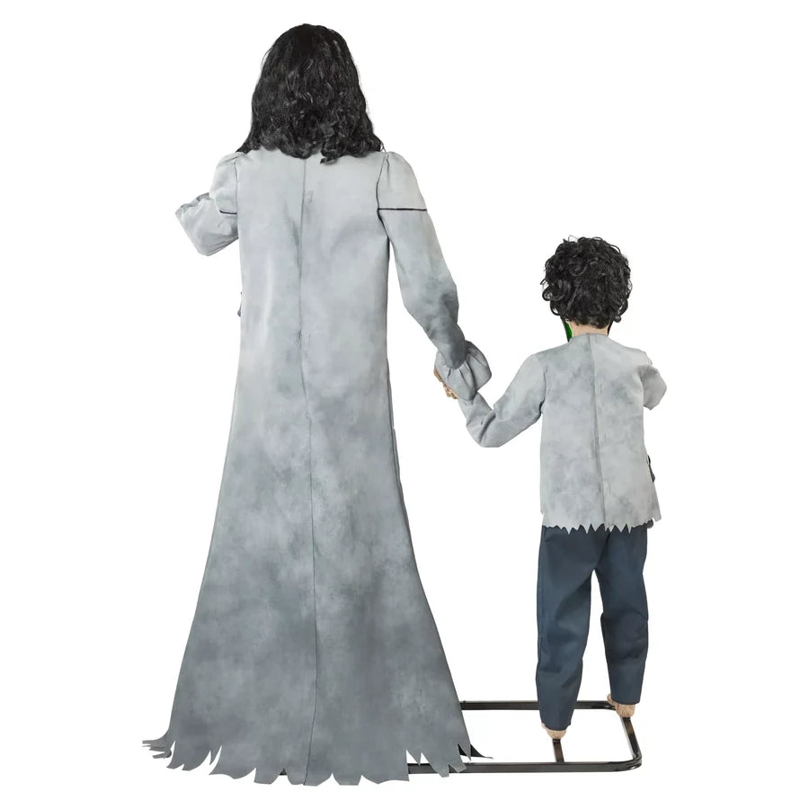 Seen from behind: the long grey smock, the shorter tunic and the joined hands between them