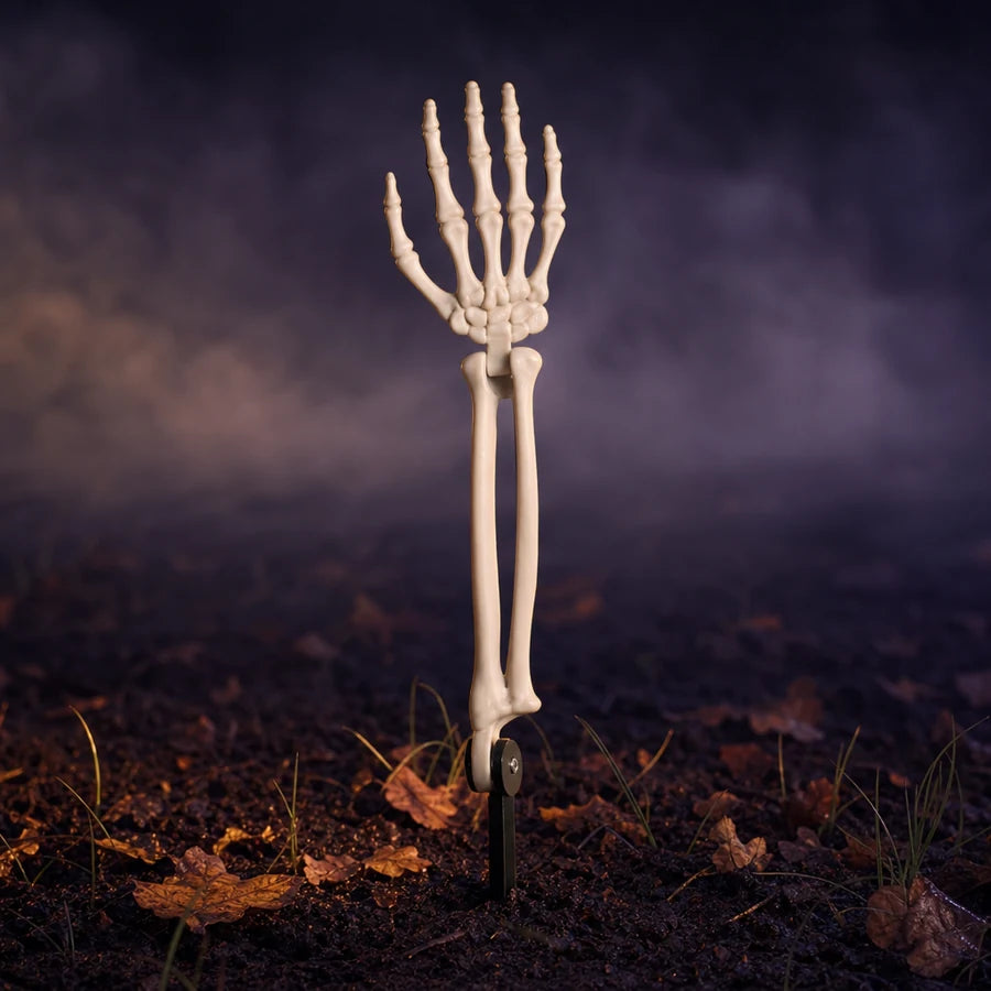 Ten bone arms staked across a night lawn, lit from below, with the Gravereach name across the foot of the frame