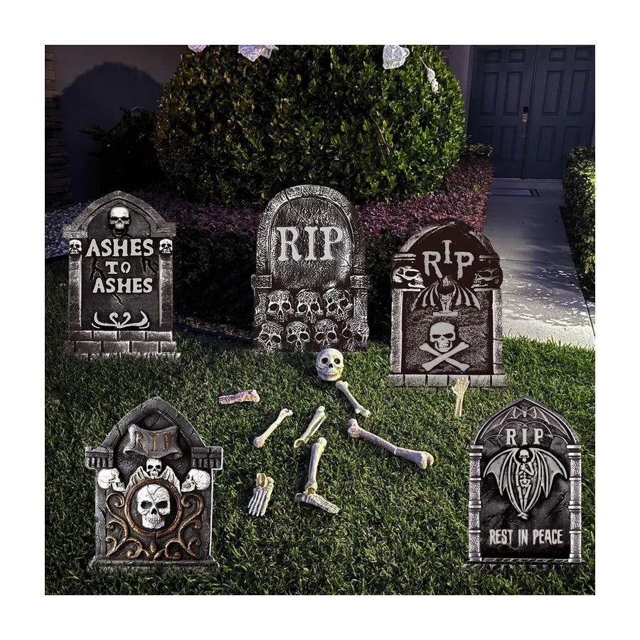 A set of grey moulded headstones staked in a lawn