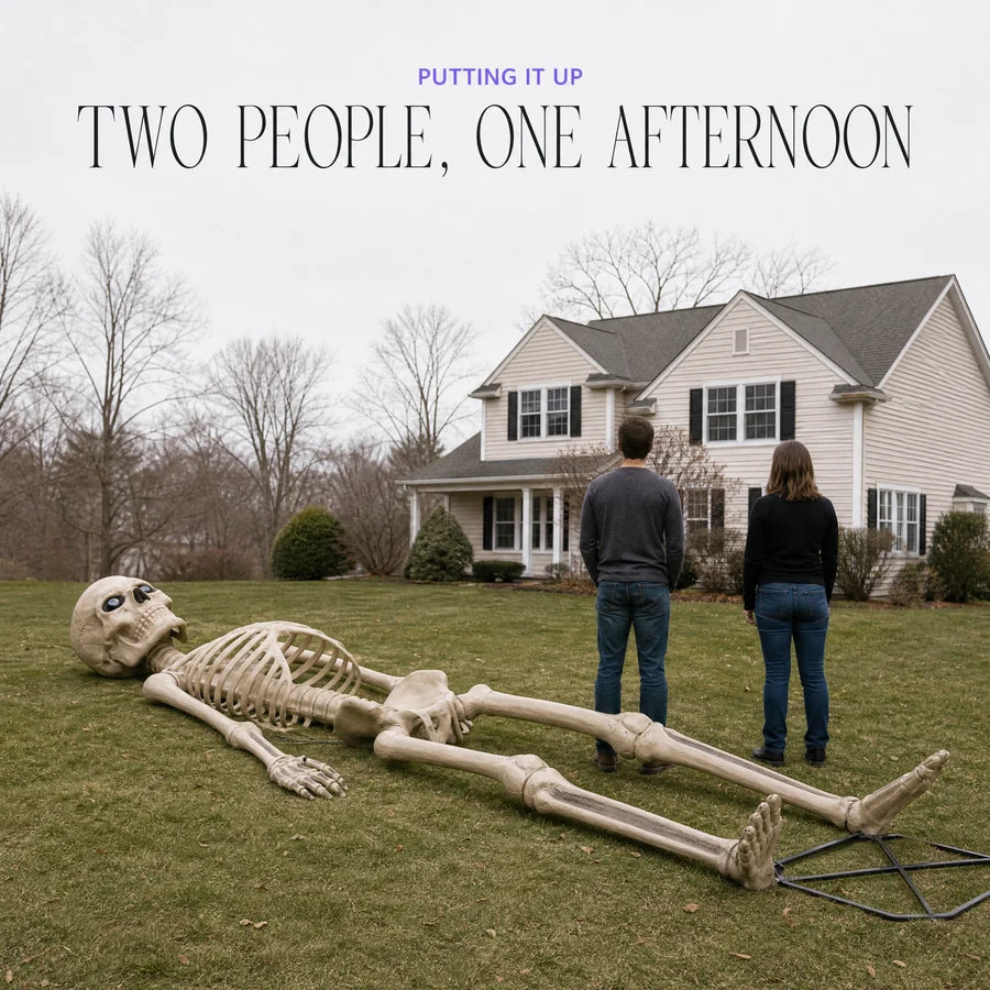 Lying full length on a lawn beside two adults, longer than both of them together