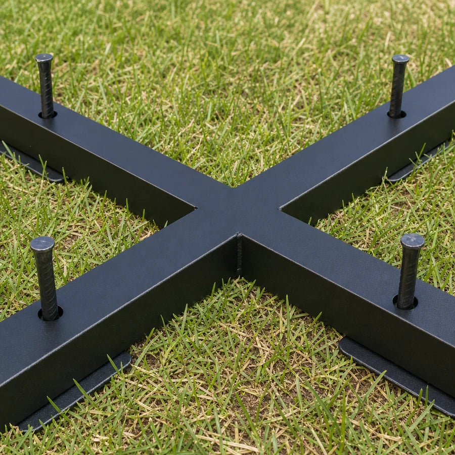 The steel base at ground level with the four included ground stakes driven into the lawn
