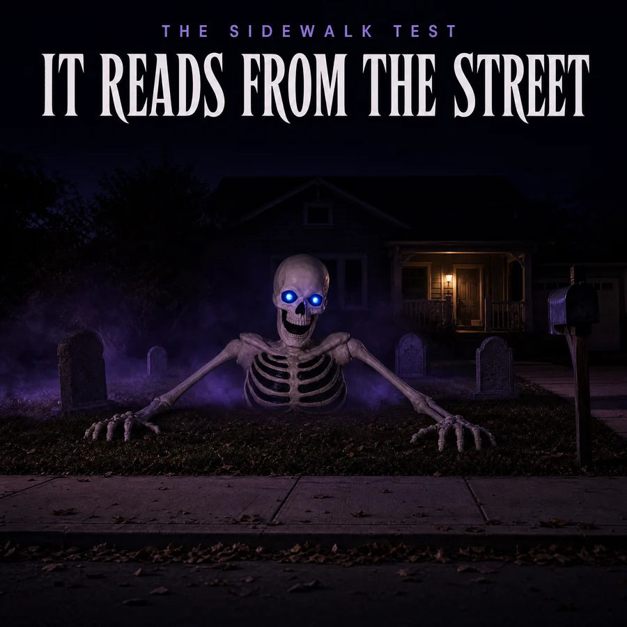 Seen from the sidewalk at night among headstones, the two lit blue eyes reading from across the lawn