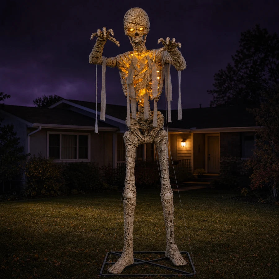 Wrackmoor 11 ft Mummy set up on a suburban front lawn at night, lit against the house