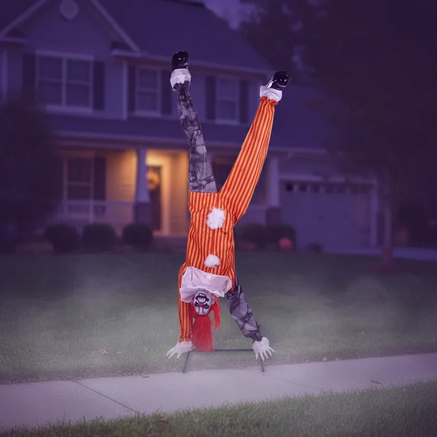Wexford Clown Animatronic set up on a suburban front lawn at night, lit against the house