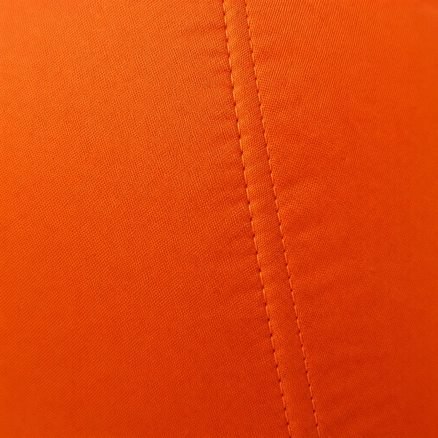 Studio macro of the ribbed orange oxford fabric with a double-stitched seam