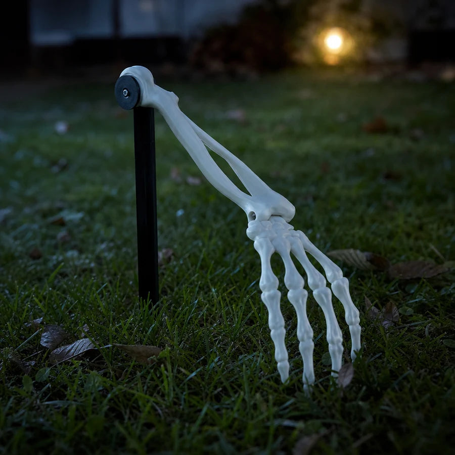 Close view of the wrist joint bending, fingers curled toward the grass
