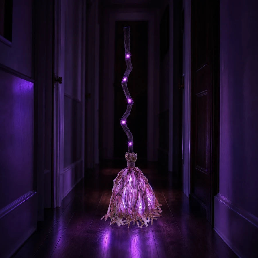 Lit violet in a dark hardwood hallway, the colour stretching down the floor