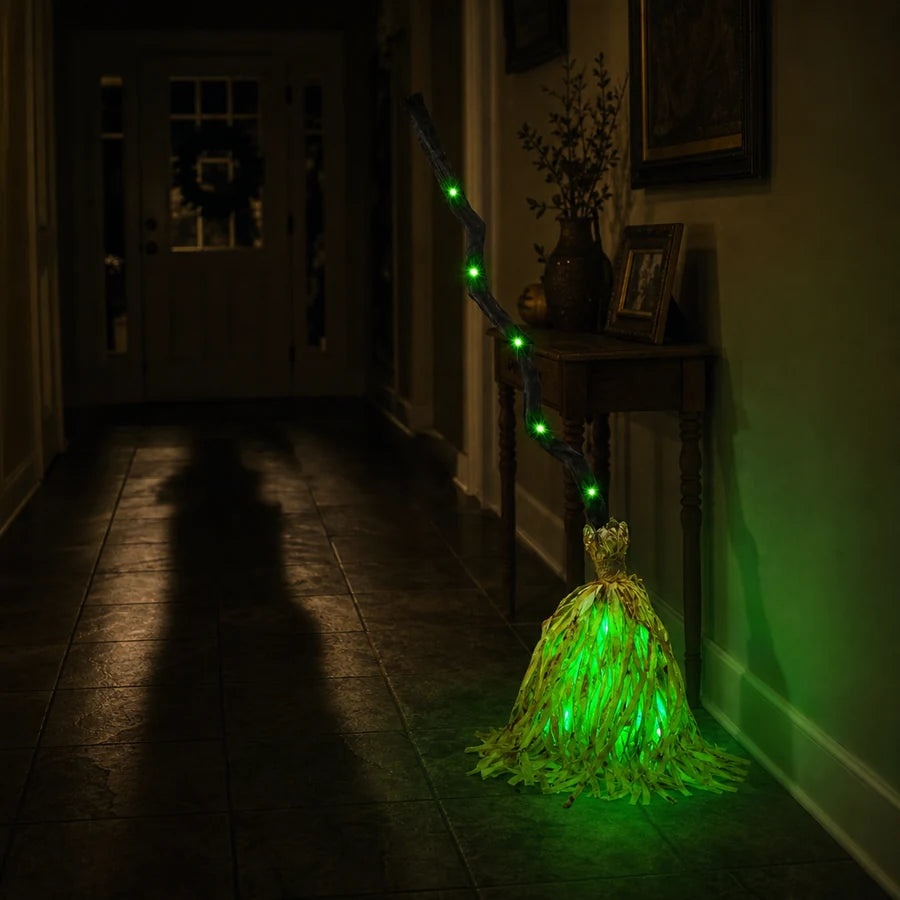 Green in a dark entry, a long shadow falling across the floor from the open doorway