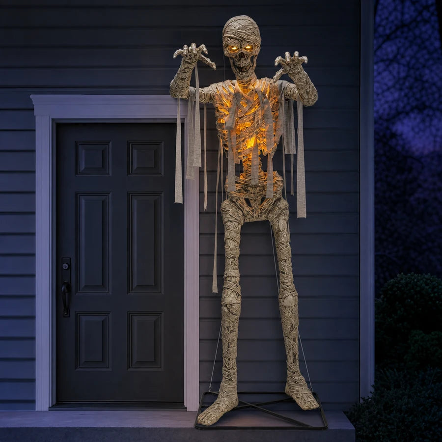 Wrackmoor 11 ft Mummy standing beside a front door, its head reaching well above the frame