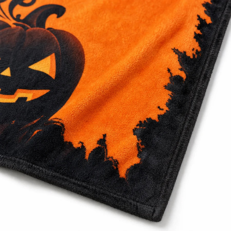Close on the charred, torn black border where it meets the orange print