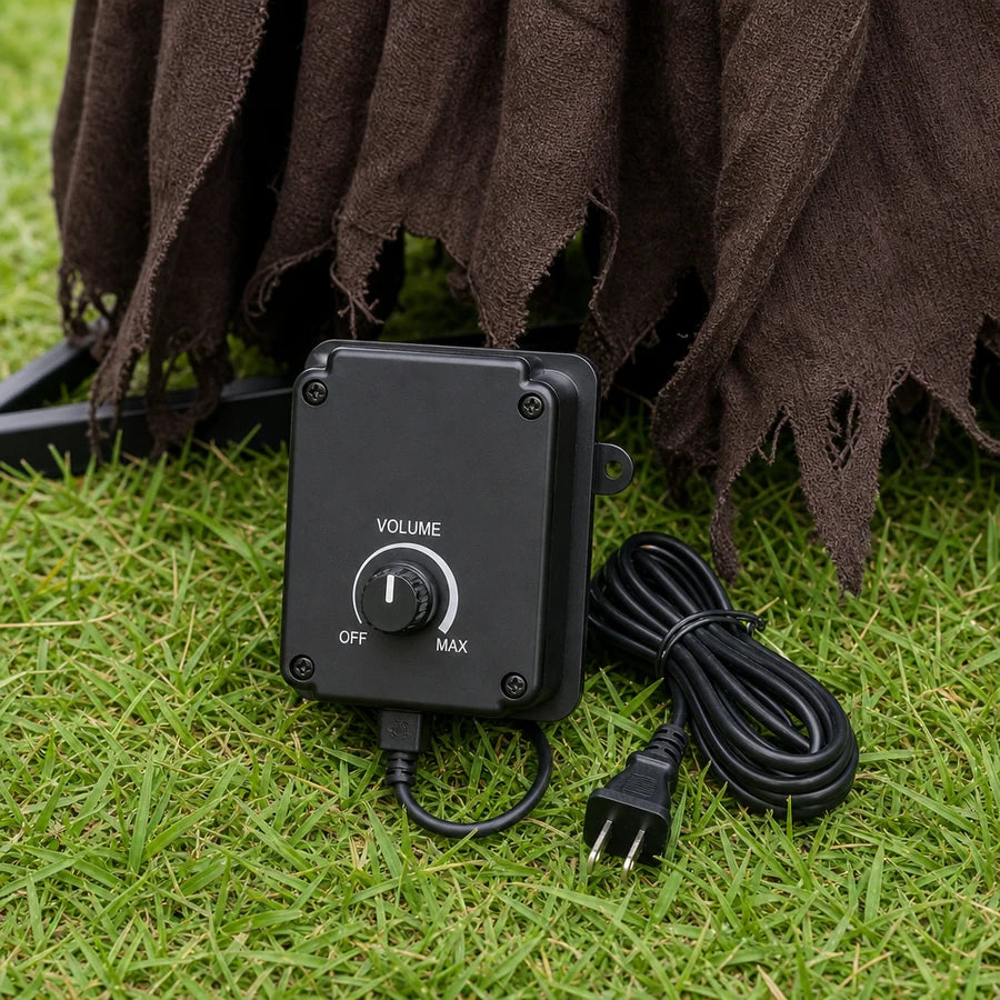 Studio macro of the black control box with its volume dial and power cord at the base of the figure