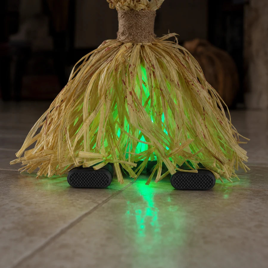 At floor level, the two grip feet that hold it upright emerging from under the bristles