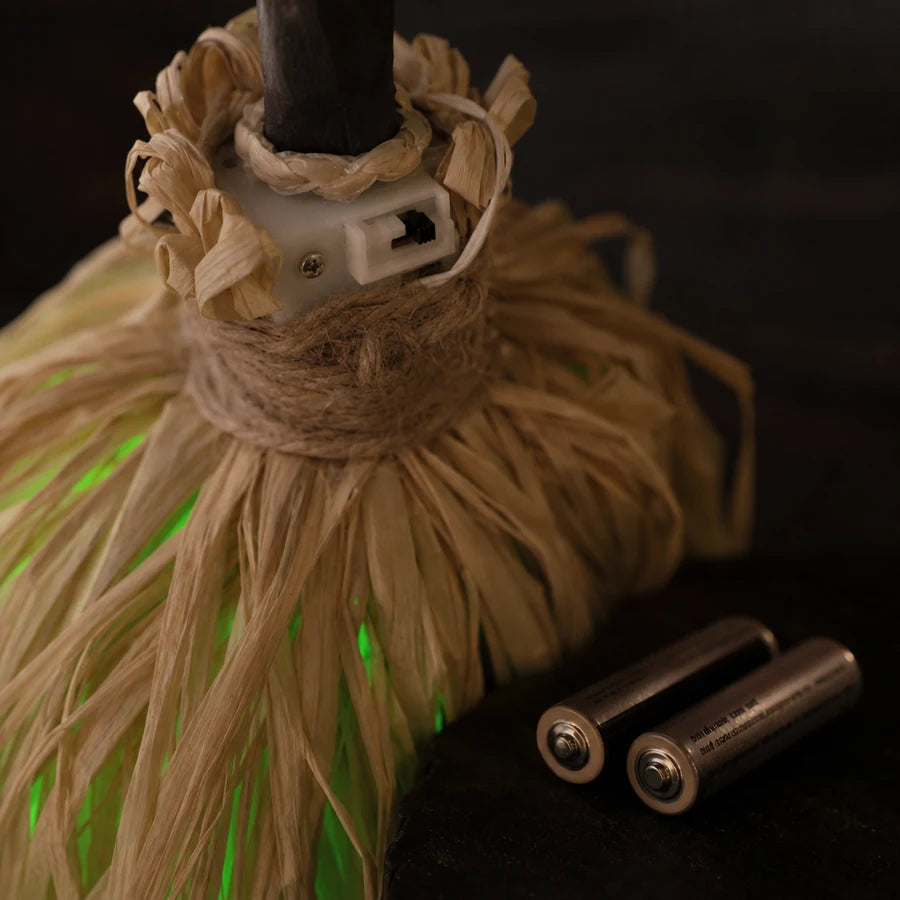 The small switch housing tucked against the twine where the handle enters the head