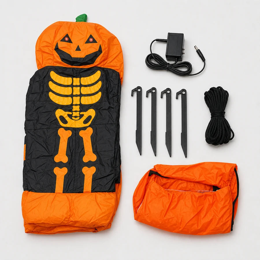 Overhead flat-lay: the folded reaper, its 12V adapter, ground stakes, tie-down ropes and sandbags