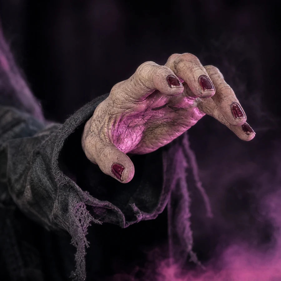 Her raised hand mid-gesture, red nails catching the pink light from the cauldron