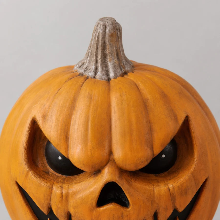 Close crop of the pumpkin stem and the top ridges of the carved head
